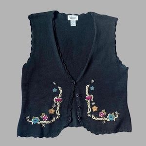crocheted cottagecore sweater vest with embroidered flowers and purple buttons